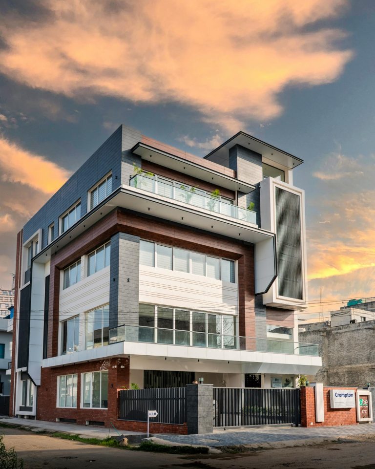 Contemporary building design against a vibrant sky in Punjab, India.